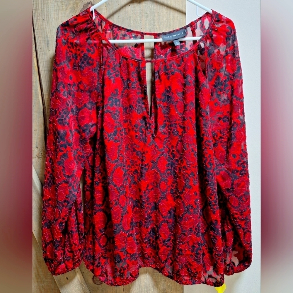 A Lane Bryant long sleeve sheer top in a size 14 with a funky red print EUC.